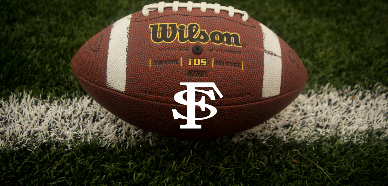 football on a field with the FS logo on it